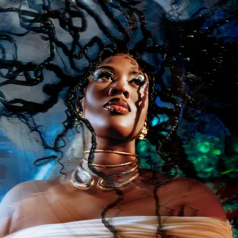 Iman Europe with long braids in blue light